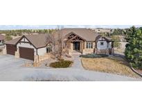 Beautiful single-Gathering home featuring stone accents, a three-car garage, and mature landscaping at 46692 Silver Fir St, Parker, CO 80138