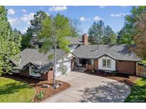Charming two-story brick home with a well-manicured front yard and driveway at 6488 S Heritage E Pl, Centennial, CO 80111