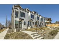 Modern townhomes with white siding, black trim, and small front yards offer contemporary living in a vibrant community at 1301 Osceola St, Denver, CO 80204
