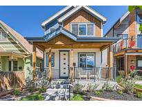Charming two-story home featuring a welcoming front porch, stylish accents, and well-maintained landscaping at 3640 Lipan St, Denver, CO 80211