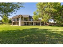 Expansive backyard with lush lawn and mature trees, perfect for outdoor living and entertaining at 15132 Pecos St, Broomfield, CO 80023