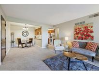 Open-concept living room with a dining area and access to the kitchen, creating a seamless flow for modern living at 519 Wright St # 106, Lakewood, CO 80228