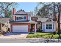 Charming two-story home featuring a brick facade, attached two car garage, and well-maintained front yard at 1206 E Phillips Pl, Littleton, CO 80122
