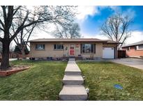 Charming brick ranch home featuring a well-maintained lawn and inviting walkway leading to the front door at 2993 S Zenobia St, Denver, CO 80236