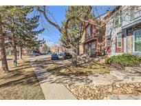 View of the street highlighting the row of townhomes and the surrounding landscaping at 12053 E Tennessee Ave, Aurora, CO 80012
