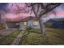 Charming single-story home with a covered parking area and a mature tree in the front yard at 1280 S Quitman St, Denver, CO 80219
