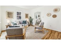 Bright living room with hardwood floors, neutral tones, and stylish furnishings at 1665 Boston St, Aurora, CO 80010