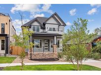 Two-story house with gray siding, stone accents, and a modern front porch at 3908 Mariposa St, Denver, CO 80211