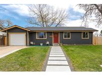 Charming single-story home with a red door, landscaped lawn, and inviting walkway at 13020 Julian Ct, Broomfield, CO 80020