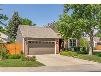 Charming home featuring a brick and siding facade, complemented by a well-manicured lawn and mature trees at 5237 S Cody St, Littleton, CO 80123