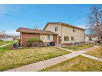 Charming home featuring well-maintained landscaping and a combination of brick and vinyl siding at 3355 S Flower St # 107, Lakewood, CO 80227