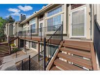 Inviting two-story townhouse featuring stairs, updated deck, and ample natural light at 1885 S Quebec Way # A28, Denver, CO 80231