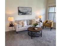 Cozy living room with neutral tones, stylish decor, and ample natural light from the nearby window at 7489 S Quail Cir # 814, Littleton, CO 80127