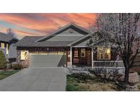 Charming single-Gathering home boasts a well-maintained front yard, covered porch, and a two-car garage, perfect for suburban living at 8199 W 67Th Ave, Arvada, CO 80004