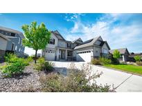 Beautiful home featuring a three-car garage, well-manicured lawn, solar panels and a long driveway at 8867 S Zante St, Aurora, CO 80016