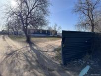 Exterior of home with long driveway and gate at 7486 Patrick St, Fort Lupton, CO 80621