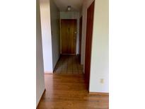View of the front door with tile, and hardwood floors in the hallway at 9335 E Center Ave # 7C, Denver, CO 80247