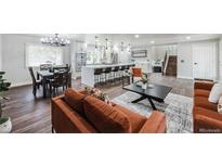 Open concept kitchen and living area with modern appliances and stylish furnishings at 10587 W Chautauga Mtn, Littleton, CO 80127