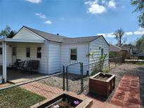 Cozy home with a fenced yard, patio area, and landscaping, perfect for outdoor living and entertaining at 8 S Kendall St, Lakewood, CO 80226