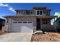 Two-story house with stone accents and a two-car garage at 393 Grey Rock St, Brighton, CO 80601