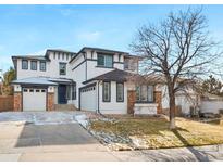 Charming two-story home with a well-manicured lawn and a two-car garage, perfect for Gathering living at 11010 Grayledge Cir, Highlands Ranch, CO 80130