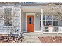 Charming front entrance with a vibrant orange door and covered porch, creating a welcoming curb appeal at 1495 Zamia Ave # 3, Boulder, CO 80304