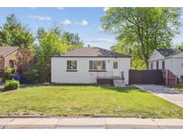 Charming single-story home with a well-manicured lawn and mature trees at 4624 S Lincoln St, Englewood, CO 80113