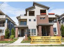 Modern two-story home with a combination of neutral stucco and brick exterior and well-maintained landscaping at 4535 W 50Th Ave, Denver, CO 80212