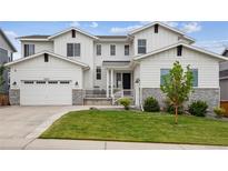 Charming two-story home with a well-manicured lawn and a two-car garage at 6679 Kenzie Cir, Castle Pines, CO 80108