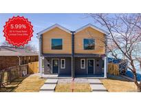 Modern duplex with gray siding, wood accents, and landscaped yards at 4341 N Columbine St, Denver, CO 80216