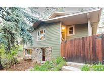 Charming home with stone accents and a rustic wooden fence for added privacy at 2795 Se Grapevine Rd, Idledale, CO 80453