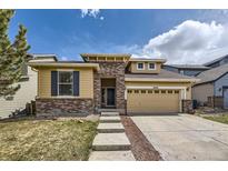 Charming two-story home with a well-manicured lawn and welcoming brick and siding exterior at 10440 Olathe, Commerce City, CO 80022