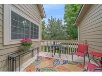 Inviting outdoor patio with colorful rug and seating, perfect for relaxing and enjoying the fresh air at 10389 W Fair Ave # E, Littleton, CO 80127