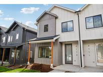 Modern townhome featuring mixed siding, a covered entry, and sleek black window frames at 4101 S Lincoln St, Englewood, CO 80113