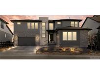 Beautiful modern two-story home with a stone facade, attached garage, and professional landscaping at 455 Rogers Way, Castle Rock, CO 80104