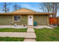 Charming single-story home with a welcoming front porch and well-maintained landscaping at 12458 E Kansas Pl, Aurora, CO 80012