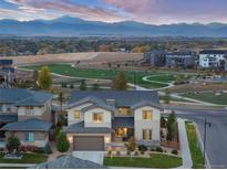 Stunning two-story home with lush landscaping and mountain views in a vibrant community with a park at 90 Moonrise Ct, Erie, CO 80516