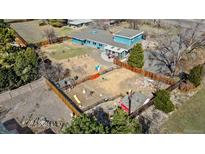 Sprawling property featuring a spacious yard with play structures and a fenced area for pets or gardening at 7400 W Quincy Ave, Littleton, CO 80123