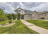 Two-story house with stone accents and landscaped front yard at 7456 S Moore Ct, Littleton, CO 80127