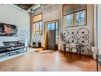 Comfortable living room featuring a desk with an industrial design, offering a stylish workspace at 2715 Blake St # 2, Denver, CO 80205