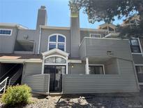 Attractive gray townhouse with private entrance and balcony, perfect for comfortable living at 931 S Zeno Way # 106, Aurora, CO 80017