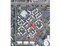 An aerial view shows the Woodstream Falls Condominiums with parking and a path leading to Sage at Panorama at 9725 E Harvard Ave # 305, Denver, CO 80231