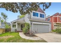Charming two-story home with light gray siding, a gray garage, and a well-manicured lawn at 744 Owl Dr, Louisville, CO 80027