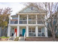 Charming two-story home featuring inviting front porches and colorful doors at 7472 E 28Th Ave, Denver, CO 80238