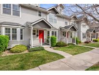Charming townhome with a red front door and well-maintained landscaping at 4395 E Jewell Ave # 3, Denver, CO 80222