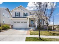 Charming two-story home boasts a two-car garage, stone accents, and a well-manicured lawn in a desirable neighborhood at 24222 E Canyon Pl, Aurora, CO 80016