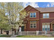 Charming two-story townhome featuring a well-maintained yard and inviting curb appeal with mature landscaping at 4061 Nordland Trl, Castle Rock, CO 80109