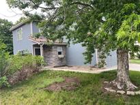 Charming two-story home with a stone facade, attractive landscaping, and mature trees in a quiet neighborhood at 2130- 42Nd Ave, Denver, CO 80249
