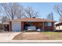A single Gathering brick home with a one car garage in need of some TLC at 415 Winona Ct, Denver, CO 80204