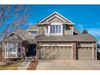 Charming two-story home featuring a three-car garage and appealing facade with brick and siding accents at 3940 Wynwood Cir, Highlands Ranch, CO 80126